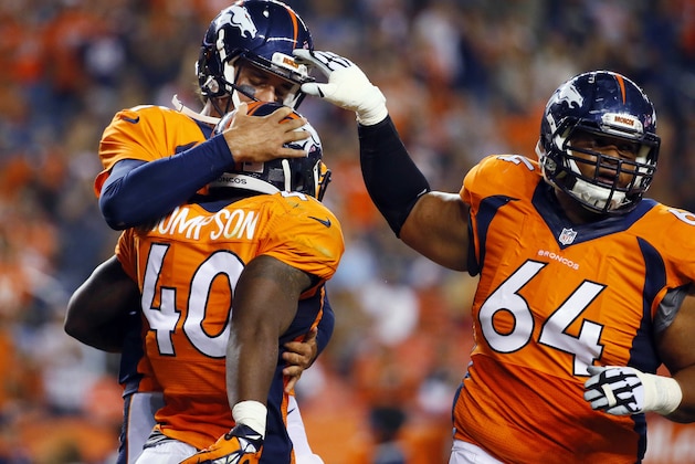 Denver Broncos running back Juwan Thompson (40) celebrates his touchdown with quarterback Brock Osweiler, rear, and Shelley Smith (64) during the second half of an NFL preseason football game against the San Francisco 49ers, Saturday, Aug. 29, 2015, in Denver. (AP Photo/Jack Dempsey)
