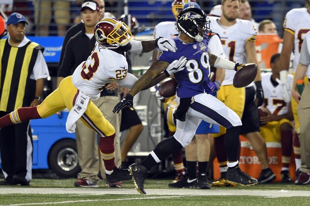 Washington Redskins cornerback DeAngelo Hall, left, chases Baltimore Ravens wide receiver Steve Smith out of bounds as Smith rushes the ball in the first half of a preseason NFL football game, Saturday, Aug. 29, 2015, in Baltimore. (AP Photo/Nick Wass)