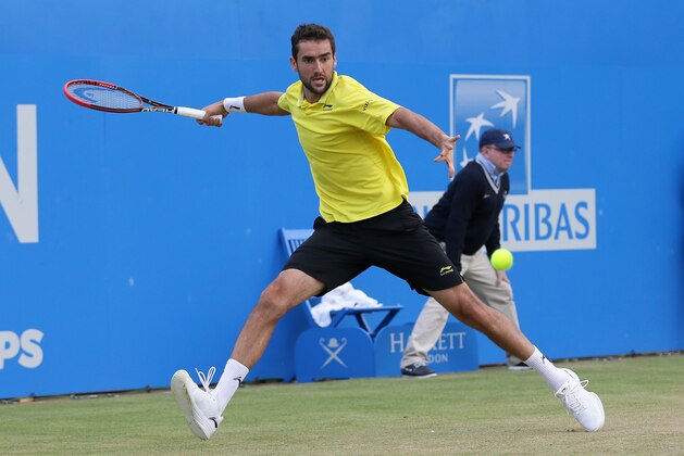Croatia's Marin Cilic plays a return to Serbia's Viktor Troicki during their singles tennis match at the Queen's Championships in London, Thursday, June 18, 2015. (AP Photo/Tim Ireland)