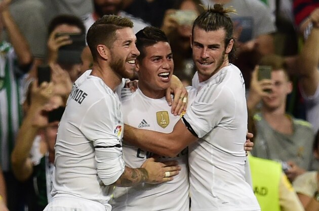Real Madrid's Colombian midfielder James Rodriguez (C) celebrates with Real Madrid's defender Sergio Ramos (L) and Real Madrid's Welsh forward Gareth Bale (R) after scoring during the Spanish league football match Real Madrid CF vs Real Betis Balompie at the Santiago Bernabeu stadium in Madrid on August 29, 2015.   AFP PHOTO/ PIERRE-PHILIPPE MARCOU        (Photo credit should read PIERRE-PHILIPPE MARCOU/AFP/Getty Images)