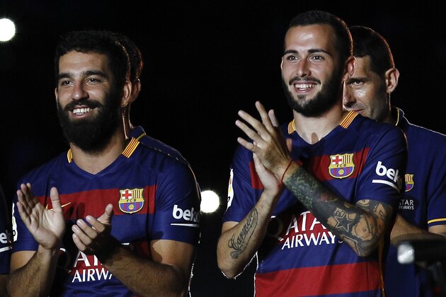 Barcelona's Turkish midfielder Arda Turan (L) and Barcelona's defender Aleix Vidal (R) stand during an official team presentation at the 50th Joan Gamper Trophy football match FC Barcelona vs AS Roma at the Camp Nou stadium in Barcelona on August 5, 2015.  AFP PHOTO / QUIQUE GARCIA        (Photo credit should read QUIQUE GARCIA/AFP/Getty Images)