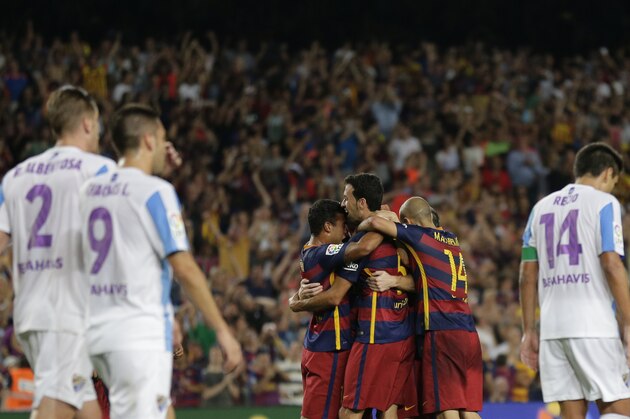 FC Barcelona's players celebrate Thomas Vermaelen's goal  against Malaga during a Spanish La Liga soccer match at the Camp Nou stadium in Barcelona, Spain, Saturday, Aug. 29, 2015. (AP Photo/Manu Fernandez)