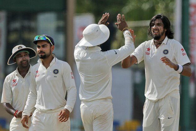 India's Ishant Sharma, right, celebrates the dismissal of Sri Lanka's Rangana Herath on the third day of their third test cricket match between them in Colombo, Sri Lanka, Sunday, Aug. 30, 2015. This was Sharma's fifth wicket. (AP Photo/Eranga Jayawardena)