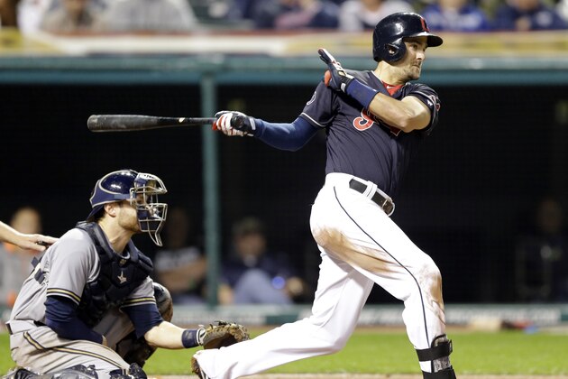 Cleveland Indians’ Lonnie Chisenhall, right, hits an RBI-single off Milwaukee Brewers relief pitcher Tyler Thornburg in the fourth inning of an interleague baseball game, Wednesday, Aug. 26, 2015, in Cleveland. Francisco Lindor scored on the play. Brewers catcher Jonathan Lucroy watches. (AP Photo/Tony Dejak)