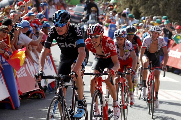Sky's British cyclist Christopher Froome (L) crosses the finish line of the seventh stage of the 2015 Vuelta Espana cycling tour, a 191.1km stage between Jodar and La Alpujarra, in Capileira on August 28, 2015.  AFP PHOTO/ JOSE JORDAN        (Photo credit should read JOSE JORDAN/AFP/Getty Images)