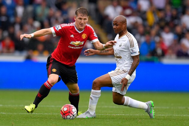 SWANSEA, WALES - AUGUST 30:  Manchester United player Bastian Schweinsteiger (l) is challenged by Andre Ayew during the Barclays Premier League match between Swansea City and Manchester United on August 30, 2015 in Swansea, United Kingdom.  (Photo by Stu Forster/Getty Images)