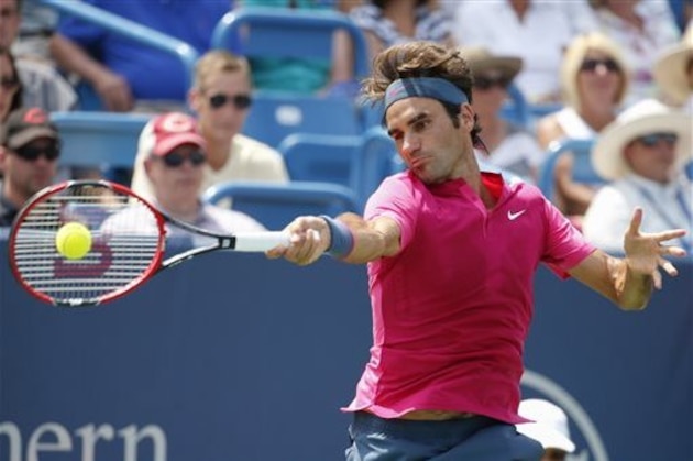 ADVANCE FOR WEEKEND EDITIONS, AUG. 29-30 - FILE -  In this Aug. 23, 2015, file photo, Roger Federer, of Switzerland, returns the ball to Novak Djokovic, of Serbia, during a final match at the Western & Southern Open tennis tournament in Mason, Ohio. Djokovic is the No. 1 seed for the 2015 U.S. Open. Federer is seeded second. (AP Photo/John Minchillo, File)
