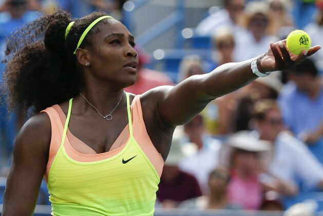 Serena Williams serves the ball to Simona Halep, of Romania, during a final match at the Western & Southern Open tennis tournament, Sunday, Aug. 23, 2015, in Mason, Ohio. Williams defeated Halep 6-3, 7-6 (5). (AP Photo/John Minchillo)