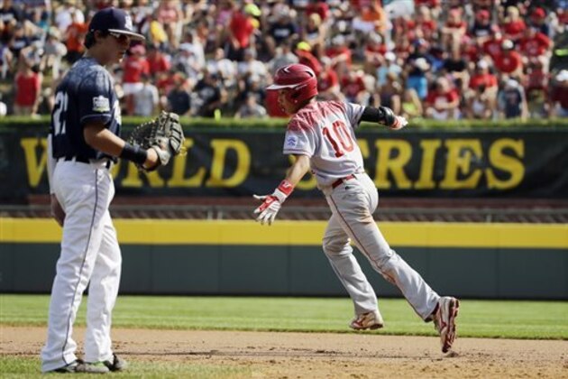 Japan's Shingo Tomita, right, reacts past Lewisberry, Pa.'s Cole Wagner after hitting a home run off Jaden Henline during the second inning of the Little League World Series Championship baseball game, Sunday, Aug. 30, 2015, in South Williamsport, Pa. (AP Photo/Matt Slocum)