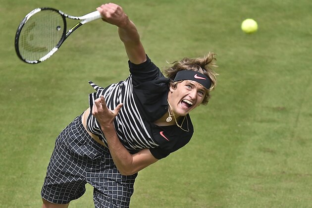Alexander Zverev from Germany serves the ball to Ivo Karlovic of Croatia during their second round match at the Gerry Weber Open ATP tennis tournament in Halle, Germany, Wednesday, June 17, 2015. (AP Photo/Martin Meissner)