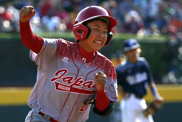 Japan's Masafuji Nishijima, left, rounds third after hitting a three-run home run off Lewisberry, Pa.'s Jaden Henline in the third inning of the Little League World Series Championship baseball game in South Williamsport, Pa., Sunday, Aug. 30, 2015. (AP Photo/Gene J. Puskar)