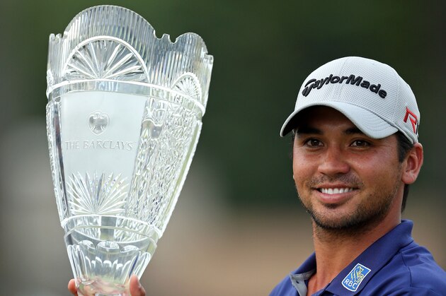 Jason Day, of Australia, holds up a trophy after winning The Barclays golf tournament Sunday, Aug. 30, 2015, in Edison, N.J. Day finished 19 under with a 261 total. (AP Photo/Adam Hunger)