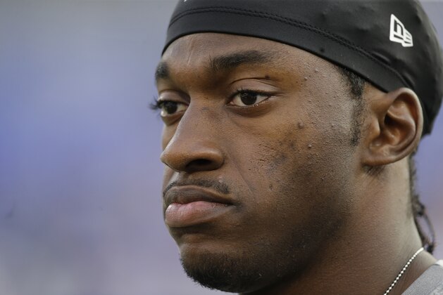 Washington Redskins quarterback Robert Griffin III walks on the field before a preseason NFL football game against the Baltimore Ravens, Saturday, Aug. 29, 2015, in Baltimore. (AP Photo/Patrick Semansky)