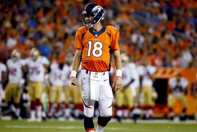 Denver Broncos quarterback Peyton Manning (18) walks off the field against the San Francisco 49ers during the first half of an NFL preseason football game, Saturday, Aug. 29, 2015, in Denver. (AP Photo/Jack Dempsey)