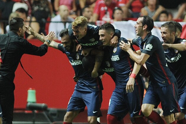 Atletico Madrid's Argentinian coach Diego Simeone (L) celebrates with his team after Atletico Madrid's Colombian forward Jackson Martínez scored a goal during the Spanish league football match Sevilla FC vs Club Atletico de Madrid at the Ramon Sanchez Pizjuan stadium in Sevilla on August 30, 2015.   AFP PHOTO/ CRISTINA QUICLER        (Photo credit should read CRISTINA QUICLER/AFP/Getty Images)
