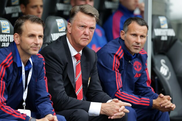 Manchester United's manager Louis van Gaal, center, waits for the start of the English Premier League soccer match between Swansea City and Manchester United at the Liberty Stadium in Swansea, Wales, Sunday, Aug. 30, 2015.  (AP Photo/Matt Dunham)