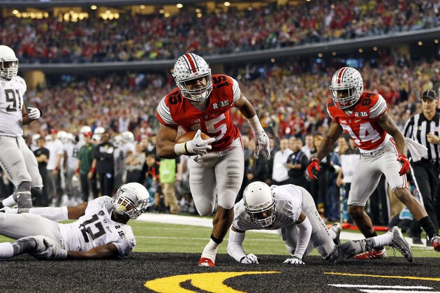 Jan 12, 2015; Arlington, TX, USA; Ohio State Buckeyes running back Ezekiel Elliott (15) scores a touchdown past Oregon Ducks defensive back Chris Seisay (12) during the game in the 2015 CFP National Championship Game at AT&T Stadium. Ohio State won 42-20. Mandatory Credit: Kevin Jairaj-USA TODAY Sports