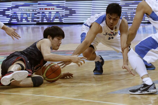 Japan's Ryota Sakurai, left, and the Philippines' Ranidel de Ocampo, battle for a loose ball in the first half of their second round game of the FIBA Asia Basketball Championship Monday Aug.5, 2013 at the Mall of Asia Arena at suburban Pasay city south of Manila, Philippines. (AP Photo/Bullit Marquez)