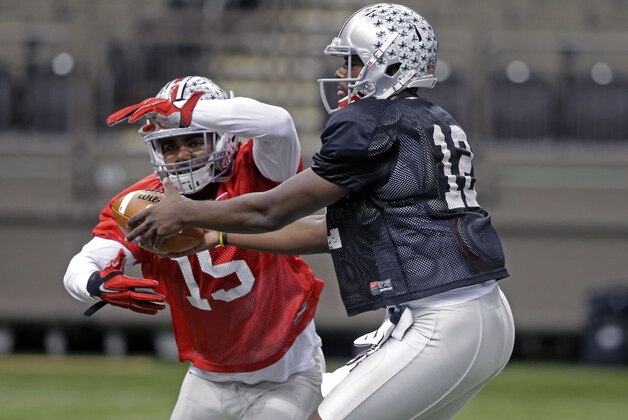 Ohio State quarterback Cardale Jones (12) hands off to running back Ezekiel Elliott (15) during practice at the Mercedes-Benz Superdome in New Orleans, Monday, Dec. 29, 2014. They will square off against Alabama in the Allstate Sugar Bowl NCAA football game, which will be played Jan. 1, 2015. (AP Photo/Gerald Herbert)