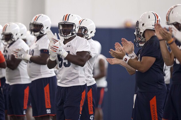 Auburn defensive lineman Carl Lawson and teammates clap during an NCAA college football practice, Wednesday, Aug. 5, 2015, in Auburn, Ala. (AP Photo/Brynn Anderson)