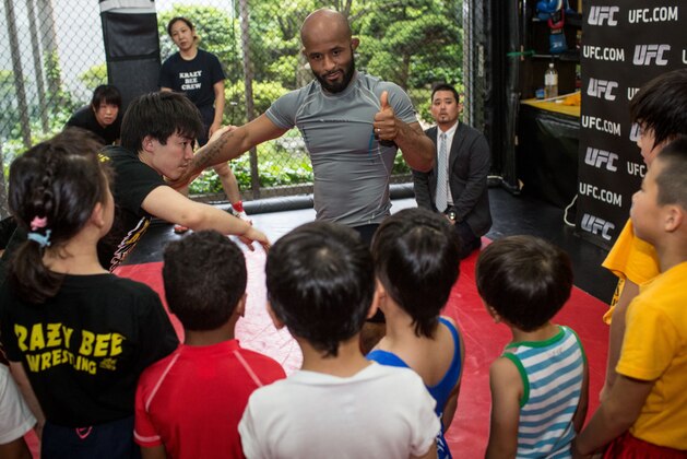 TOKYO, JAPAN - MAY 18:  Current UFC Flyweight Champion Demetrious Johnson  gives instructions to young wrestling students during a class at Krazy Bee Gym on May 18, 2015 in Tokyo, Japan.  (Photo by Chris McGrath/Zuffa LLC/Zuffa LLC)