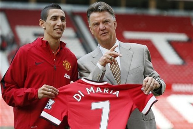 Manchester United's new player Angel Di Maria left, and manager Louis van Gaal, pose for photographers holding his new shirt, at Old Trafford Stadium in Manchester, England, Thursday, Aug. 28, 2014. Manchester United have signed winger Angel Di Maria from Real Madrid for a British record transfer fee of £59.7m. The Argentine winger had a medical in Manchester on Tuesday and has signed a five-year deal. (AP Photo/Alastair Grant)