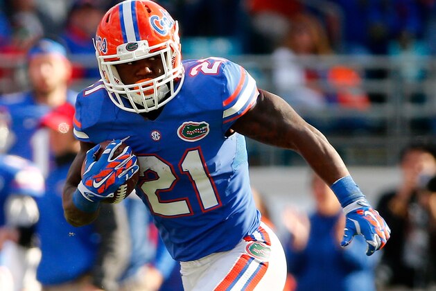 JACKSONVILLE, FL - NOVEMBER 01: Kelvin Taylor #21 of the Florida Gators runs for yardage during the game against the Georgia Bulldogs at EverBank Field on November 1, 2014 in Jacksonville, Florida.  (Photo by Sam Greenwood/Getty Images)