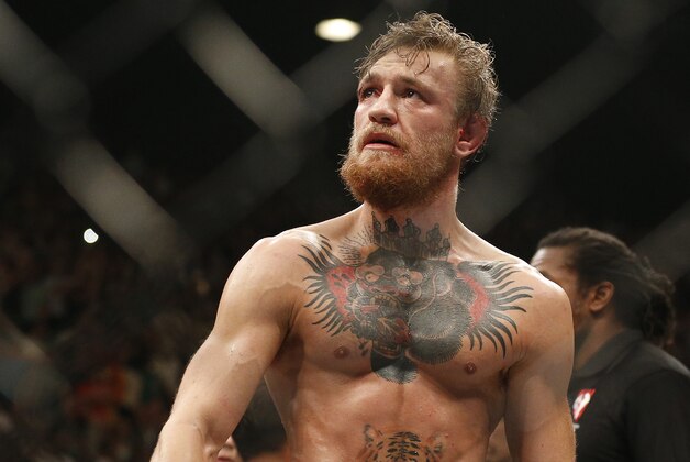 Conor McGregor celebrates after defeating Chad Mendes during their interim featherweight title mixed martial arts bout at UFC 189 Saturday, July 11, 2015, in Las Vegas. (AP Photo/John Locher)