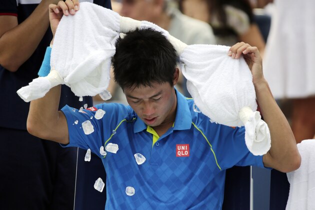 Ice falls from a towel as Kei Nishikori, of Japan, tries to cool off between games during the first round of the U.S. Open tennis tournament against Benoit Paire, of France, Monday, Aug. 31, 2015, in New York. (AP Photo/Charles Krupa)