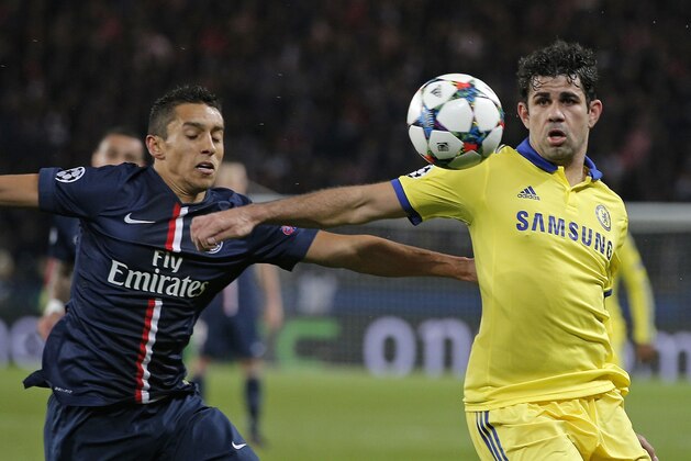 Chelsea's Diego Costa, right, holds off PSG's Marquinhos during the Champions League round of 16 first leg soccer match between Paris Saint Germain and Chelsea at the Parc des Princes stadium in Paris, France, Tuesday, Feb. 17, 2015. (AP Photo/Christophe Ena)