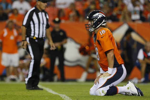 Denver Broncos quarterback Peyton Manning (18) kneels after a hit against the San Francisco 49ers during the first half of an NFL preseason football game, Saturday, Aug. 29, 2015, in Denver. (AP Photo/Joe Mahoney)