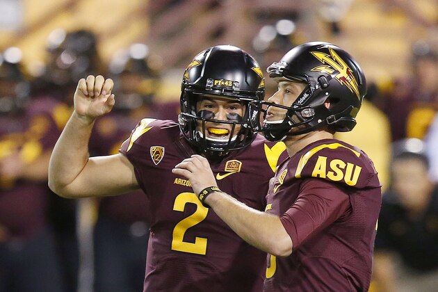 Arizona State's Zane Gonzalez, right, celebrates his game-winning field goal against Utah with teammate Mike Bercovici (2) in overtime of an NCAA college football game on Saturday, Nov. 1, 2014, in Tempe, Ariz.  Arizona State defeated the Utah 19-16 in overtime. (Photo/Ross D. Franklin)