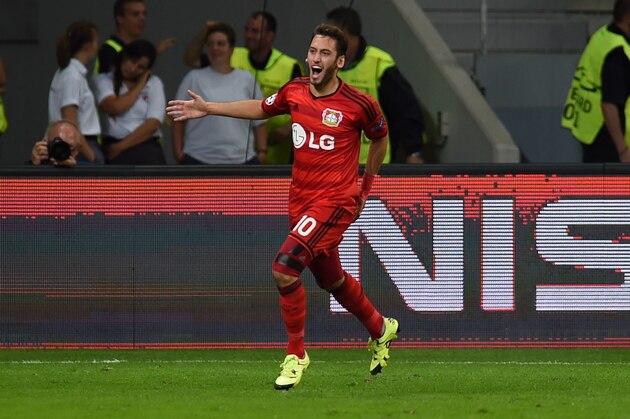Leverkusen's midfielder Hakan Calhanoglu celebrates scoring during the UEFA Champions League playoff football match between Bayer Leverkusen and SS Lazio, in Leverkusen, western Germany, on August 26, 2015.  AFP PHOTO / PATRIK STOLLARZ        (Photo credit should read PATRIK STOLLARZ/AFP/Getty Images)