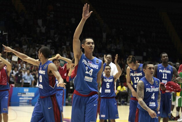 Japeth Aguilar of the Philippines, center, waves with teammates after winning the Group B Basketball World Cup match against Senegal in Seville, Spain, Thursday, Sept. 4, 2014. The 2014 Basketball World Cup competition will take place in various cities in Spain from Aug. 30 through to Sept. 14. (AP Photo/Miguel Angel Morenatti)