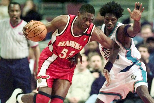 Atlanta Hawks' Dikembe Mutombo (55) drives against Detroit Pistons' Ben Wallace (3) in the second half Wednesday, Dec. 13, 2000, in Auburn Hills, Mich. Mutombo was held scoreless in the game and pulled in just six rebounds in their 92-69 loss. (AP Photo/Duane Burleson)