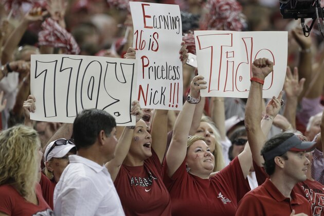 Alabama fans cheer for the Crimson Tide in the first half of an NCAA college football game  against Virginia Tech in Atlanta Saturday, Aug. 31, 2013. (AP Photo/Dave Martin)