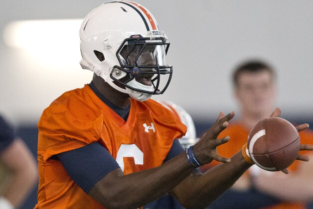 Auburn quarterback Jeremy Johnson (6) makes a catch during an NCAA college football practice, Tuesday, Aug. 4, 2015, in Auburn, Ala. (AP Photo/Brynn Anderson) Auburn quarterback Jeremy Johnson (6) makes a catch during an NCAA college football practice, Tuesday, Aug. 4, 2015, in Auburn, Ala. (AP Photo/Brynn Anderson)