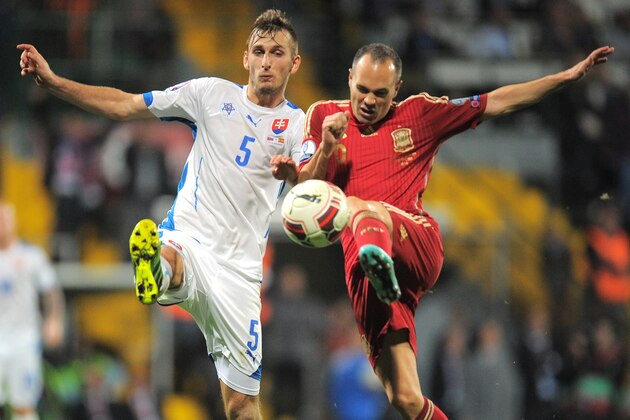 Spain's Andres Iniesta (R) and Slovakia's Norbert Gyomberfight for a ball during Euro 2016 qualifing football match between Slovakia and Spain in northern Slovak town of Zilina on October 9, 2014. AFP PHOTO / JOE KLAMAR (Photo credit should read JOE KLAMAR/AFP/Getty Images) Spain's Andres Iniesta (R) and Slovakia's Norbert Gyomberfight for a ball during Euro 2016 qualifing football match between Slovakia and Spain in northern Slovak town of Zilina on October 9, 2014. AFP PHOTO / JOE KLAMAR (Photo credit should read JOE KLAMAR/AFP/Getty Images)