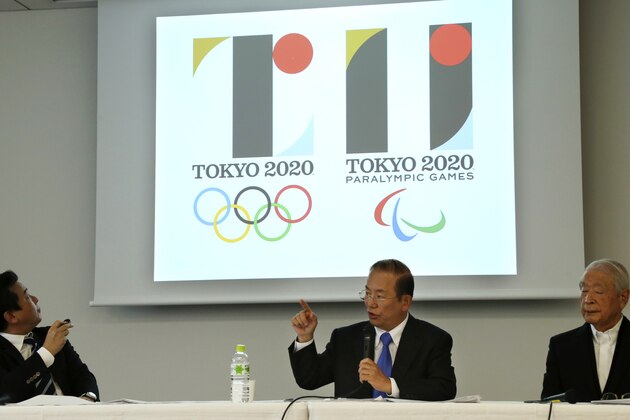 Tokyo 2020 Olympics CEO Toshiro Muto, center, speaks in front of the logo, left, of the 2020 Games during a press conference in Tokyo, Friday, Aug. 28, 2015. Tokyo Olympic organizers defended Japanese designer Kenjiro Sano in a logo scandal, denying allegation his design for the 2020 Games was taken from a Belgian theater. The organizers disclosed Sano’s initially submitted logo, saying its emphasis on “T” shape had no resemblance to that of Theater de Liege and that a circle on the background was added later when his design was touched up. The log at right is of the 2020 Paralympic Games. Others are Tokyo 2020 Olympics marketing bureau executive director Hidetoshi Maki, left, and Kazumasa Nagai, a member of the emblem design selection panel. (AP Photo/Koji Sasahara)