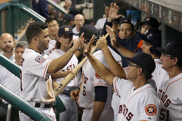 Aug 31, 2015; Houston, TX, USA; Houston Astros second baseman Jose Altuve (27) scores and is congratulated by teammates after he scored against the Seattle Mariners in the bottom of the seventh inning at Minute Maid Park. Astros won 8 to 3. Mandatory Credit: Thomas B. Shea-USA TODAY Sports