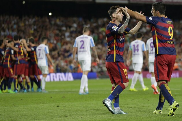 FC Barcelona's Lionel Messi, from Argentina, second right, celebrates with his teammate Luis Suarez, from Uruguay, after Thomas Vermaelen scored against Malaga during a Spanish La Liga soccer match at the Camp Nou stadium in Barcelona, Spain, Saturday, Aug. 29, 2015. (AP Photo/Manu Fernandez)
