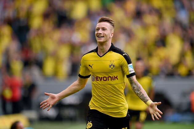 Dortmund's striker Marco Reus celebrates after scoring during the German first division Bundesliga football match Borussia Dortmund vs Borussia Moenchengladbach in Dortmund, western Germany, on August 15, 2015.  AFP PHOTO / PATRIK STOLLARZ

RESTRICTIONS: DURING MATCH TIME: DFL RULES TO LIMIT THE ONLINE USAGE TO 15 PICTURES PER MATCH AND FORBID IMAGE SEQUENCES TO SIMULATE VIDEO. 
== RESTRICTED TO EDITORIAL USE ==
FOR FURTHER QUERIES PLEASE CONTACT DFL DIRECTLY AT + 49 69 650050.        (Photo credit should read PATRIK STOLLARZ/AFP/Getty Images)