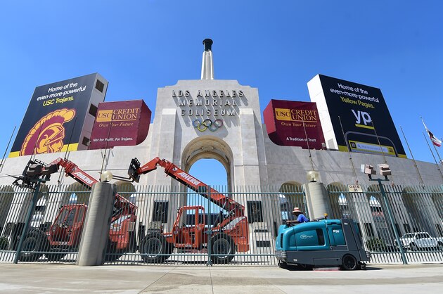 A worker manouevers is vehicle past an entrance to the Los Angeles Coliseum, which played host to the 1932 and 1984 Summer Olympics, in Los Angeles, California on August 31, 2015. The Los Angeles city Council members vote September 1,on the city's bid for the 2024 Olympics in a move seen as an important step toward securing nomination as a candidate by the US Olympic Committee. AFP PHOTO /FREDERIC J.BROWN        (Photo credit should read FREDERIC J. BROWN/AFP/Getty Images)