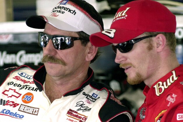 NASCAR drivers Dale Earnhardt, left, and his son Dale Jr., stand together during a break in practice Friday afternoon, Feb. 9, 2001, at the Daytona International Speedway in Daytona Beach, Fla. (AP Photo/Paul Kizzle)