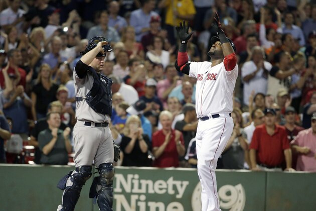 Boston Red Sox designated hitter David Ortiz, right, celebrates his home run as he arrives at home plate as New York Yankees catcher Brian McCann, left, looks on in the fourth inning of a baseball game, Monday, Aug. 31, 2015, at Fenway Park, in Boston. (AP Photo/Steven Senne)