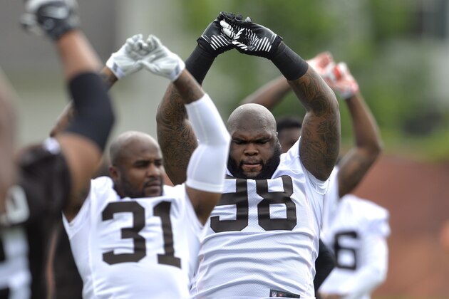 Cleveland Browns defensive lineman Phil Taylor (98) and defensive back Donte Whitner (31) stretch during an NFL football organized team activity, Tuesday, May 26, 2015, in Berea, Ohio. (AP Photo/David Richard)