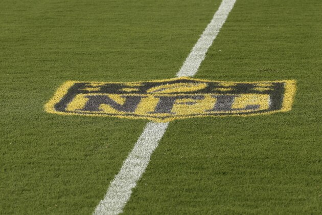 A gold NFL logo is painted on the field before an NFL football game between the Kansas City Chiefs and the Seattle Seahawks at Arrowhead Stadium in Kansas City, Mo., Friday, Aug. 21, 2015. (AP Photo/Charlie Riedel)