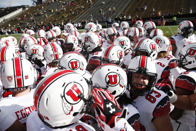 Utah Utes gather in huddle before facing Colorado in the first quarter of Utah's 38-34 victory in an NCAA college football game in Boulder, Colo., on Saturday, Nov. 29, 2014. (AP Photo/David Zalubowski)