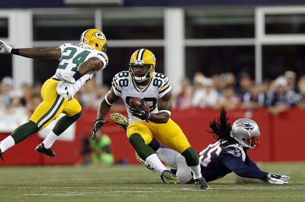 Green Bay Packers wide receiver Ty Montgomery (88) eludes New England Patriots defensive back Jimmy Jean (35) during a punt return in the first half of an NFL preseason football game Thursday, Aug. 13, 2015, in Foxborough, Mass. (AP Photo/Michael Dwyer)