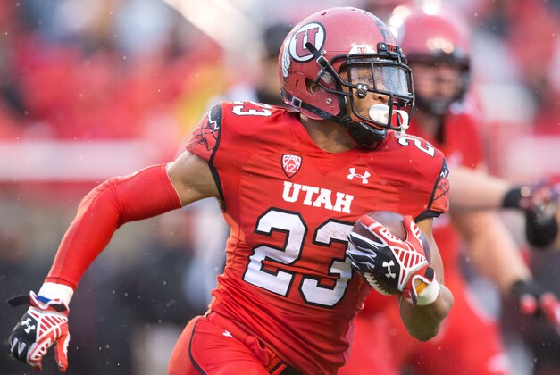 Nov 22, 2014; Salt Lake City, UT, USA; Utah Utes running back Devontae Booker (23) runs with the ball during the first half against the Arizona Wildcats at Rice-Eccles Stadium. Mandatory Credit: Russ Isabella-USA TODAY Sports